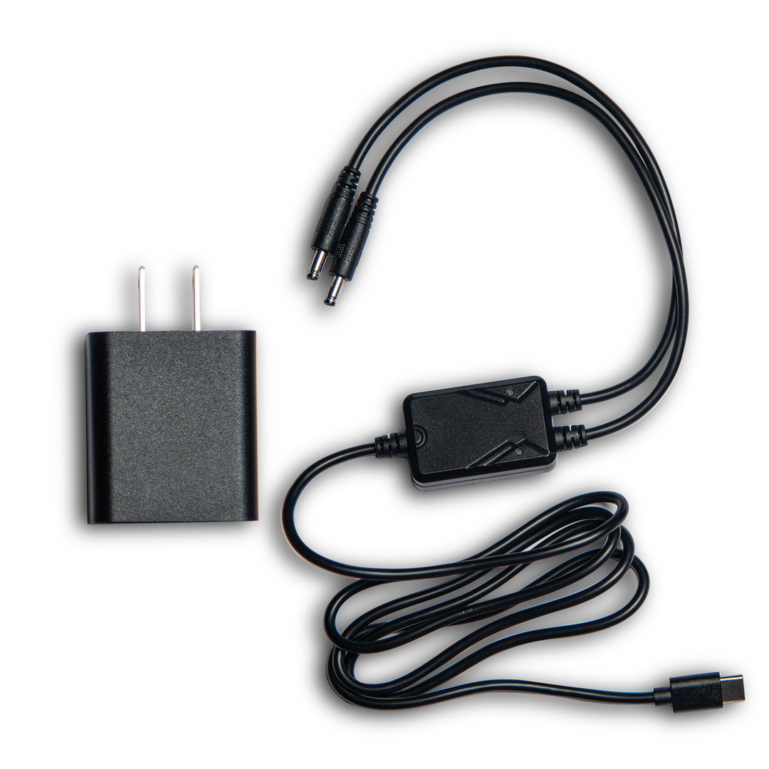 Black electronic adapter with power cable on a white background